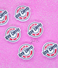 Stickers with 'Fueled by Iced Coffee and True Crime' text on a pink glitter background